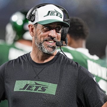 Aug 17, 2024; Charlotte, North Carolina, USA;  New York Jets quarterback Aaron Rodgers (8) shares a laugh on the sidelines during the second half against the Carolina Panthers at Bank of America Stadium. Mandatory Credit: Jim Dedmon-Imagn Images