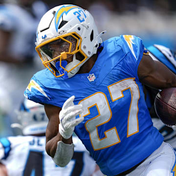 Sep 15, 2024; Charlotte, North Carolina, USA;  Los Angeles Chargers running back J.K. Dobbins (27) turns the corner away from Carolina Panthers linebacker Josey Jewell (47) for a touchdown run during the second quarter at Bank of America Stadium. Mandatory Credit: Jim Dedmon-Imagn Images