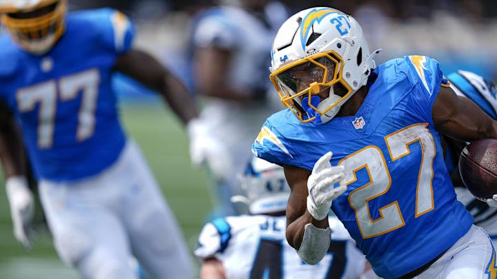 Sep 15, 2024; Charlotte, North Carolina, USA;  Los Angeles Chargers running back J.K. Dobbins (27) turns the corner away from Carolina Panthers linebacker Josey Jewell (47) for a touchdown run during the second quarter at Bank of America Stadium. Mandatory Credit: Jim Dedmon-Imagn Images