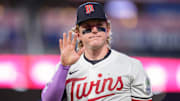 Jul 26, 2025; Minneapolis, Minnesota, USA; Minnesota Twins left fielder Harrison Bader (12) waves at a fan while walking to the dugout after the ninth inning against the Washington Nationals at Target Field. Mandatory Credit: Matt Blewett-Imagn Images