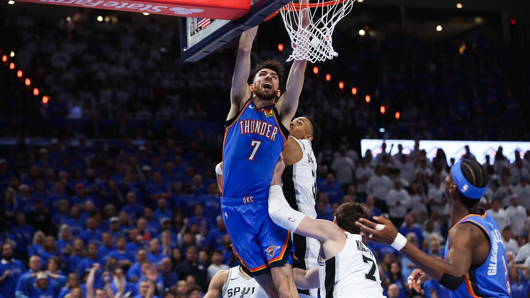 May 20, 2026; Oklahoma City, Oklahoma, USA; Oklahoma City Thunder center Chet Holmgren (7) dunks as San Antonio Spurs center Luke Kornet (7) defends during the third quarter during game two of the western conference finals for the 2026 NBA playoffs at Paycom Center. Mandatory Credit: Brett Rojo-Imagn Images