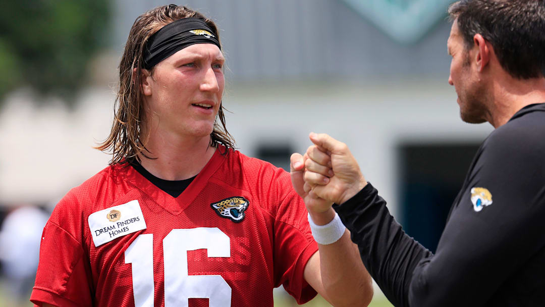 Jacksonville Jaguars quarterback Trevor Lawrence (16) fist bumps executive vice president of football operations Tony Boselli during the first organized team activity at Miller Electric Center Monday, May 19, 2025 in Jacksonville, Fla.