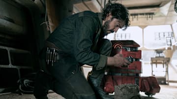 (L-R): Cassian Andor (Diego Luna) and B2EMO in Lucasfilm's ANDOR, exclusively on Disney+. ©2022 Lucasfilm Ltd. & TM. All Rights Reserved.