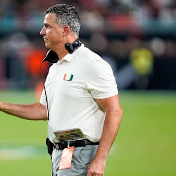 Nov 8, 2025; Miami Gardens, Florida, USA; Miami Hurricanes head coach Mario Cristobal gives his team instructions against the Syracuse Orange during the third quarter at Hard Rock Stadium. Mandatory Credit: Jeff Romance-Imagn Images