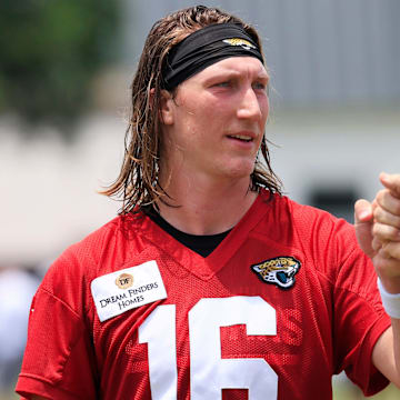 Jacksonville Jaguars quarterback Trevor Lawrence (16) fist bumps executive vice president of football operations Tony Boselli during the first organized team activity at Miller Electric Center Monday, May 19, 2025 in Jacksonville, Fla.