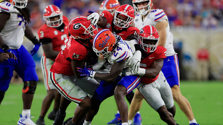 Florida running back Ja'Kobi Jackson (24) is stopped by Georgia defensive linemen Mykel Williams (13) and Christen Miller (52) and linebacker Raylen Wilson (5) on Nov. 2, 2024 at EverBank Stadium in Jacksonville, Fla. Georgia won 34-20.