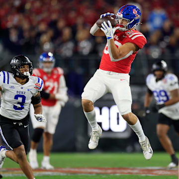 Mississippi Rebels tight end Caden Prieskorn (86) hauls in a reception between Duke Blue Devils linebacker Alex Howard (3) and safety DaShawn Stone (8) during the first quarter of the TaxSlayer Gator Bowl Thursday, Jan. 2, 2025 at EverBank Stadium in Jacksonville, Fla. [Corey Perrine/Florida Times-Union]