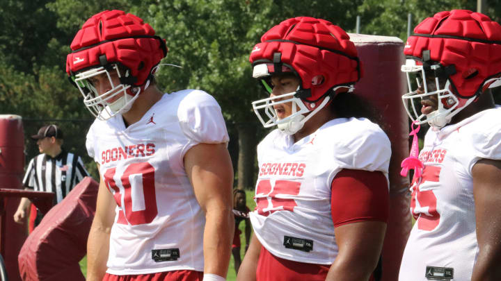 Oklahoma defensive linemen Ethan Downs (40) and Jayden Jackson (65) look on at a practice during OU's fall camp.