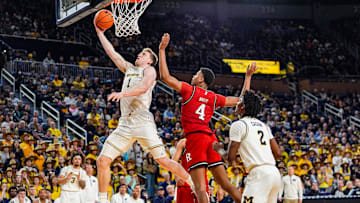 Michigan Wolverines center Danny Wolf (1) lays it up against Rutgers Scarlet Knights guard Ace Bailey (4) during the second half at Crisler Center in Ann Arbor on Thursday, Feb. 27, 2025.