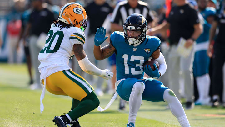 Jacksonville Jaguars wide receiver Christian Kirk (13) tries to manuver past Green Bay Packers safety Javon Bullard (20) during the third quarter of an NFL football matchup Sunday, Oct. 27, 2024 at EverBank Stadium in Jacksonville, Fla. The Packers edged the Jaguars 30-27 on a last-second field goal. 