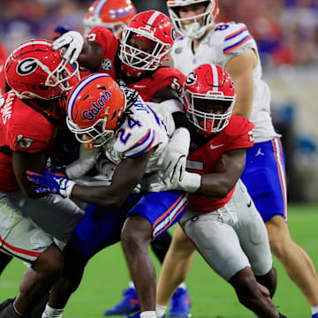 Florida running back Ja'Kobi Jackson (24) is stopped by Georgia defensive linemen Mykel Williams (13) and Christen Miller (52) and linebacker Raylen Wilson (5) on Nov. 2, 2024 at EverBank Stadium in Jacksonville, Fla. Georgia won 34-20.