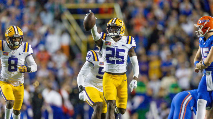 Nov 11, 2023; Baton Rouge, Louisiana, USA; LSU Tigers safety Javien Toviano (25) recovers a fumble against the Florida Gators during the first half at Tiger Stadium. Mandatory Credit: Stephen Lew-USA TODAY Sports