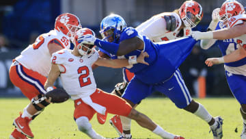 Clemson Tigers quarterback Cade Klubnik (2) is sacked by Kentucky Wildcats defensive lineman Deone Walker (0) during the third quarter of an NCAA football matchup in the TaxSlayer Gator Bowl Friday, Dec. 29, 2023 at EverBank Stadium in Jacksonville, Fla. The Clemson Tigers edged the Kentucky Wildcats 38-35. [Corey Perrine/Florida Times-Union]