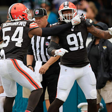 Cleveland Browns defensive end Alex Wright (91) celebrates his sack on Jacksonville Jaguars quarterback Trevor Lawrence (16) in the end zone for a safety with defensive end Ogbo Okoronkwo (54) during the fourth quarter of an NFL football matchup Sunday, Sept. 15, 2024 at EverBank Stadium in Jacksonville, Fla. The Browns defeated the Jaguars 18-13. [Corey Perrine/Florida Times-Union]