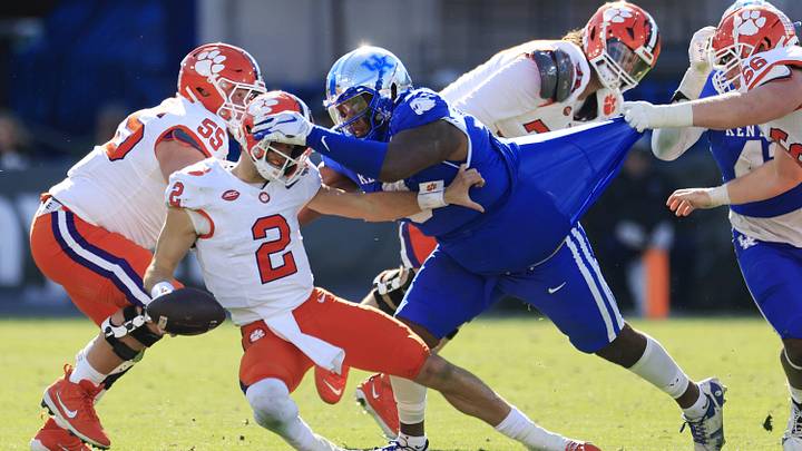 Clemson Tigers quarterback Cade Klubnik (2) is sacked by Kentucky Wildcats defensive lineman Deone Walker (0) during the third quarter of an NCAA football matchup in the TaxSlayer Gator Bowl Friday, Dec. 29, 2023 at EverBank Stadium in Jacksonville, Fla. The Clemson Tigers edged the Kentucky Wildcats 38-35. [Corey Perrine/Florida Times-Union]