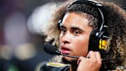 Oct 20, 2023; Carrollton, GA, USA; Carrollton Trojans quarterback Julian Lewis (10) watches on from the sidelines against the Westlake Lions during the first half at Grisham Stadium. 