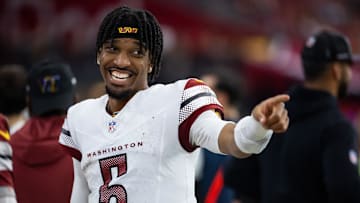 Sep 29, 2024; Glendale, Arizona, USA; Washington Commanders quarterback Jayden Daniels (5) celebrates against the Arizona Cardinals at State Farm Stadium. Mandatory Credit: Mark J. Rebilas-Imagn Images