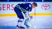Jan 3, 2025; Vancouver, British Columbia, CAN; Vancouver Canucks goalie Kevin Lankinen (32) listens to the anthem prior to the start of a game against the Nashville Predators at Rogers Arena. Mandatory Credit: Bob Frid-Imagn Images
