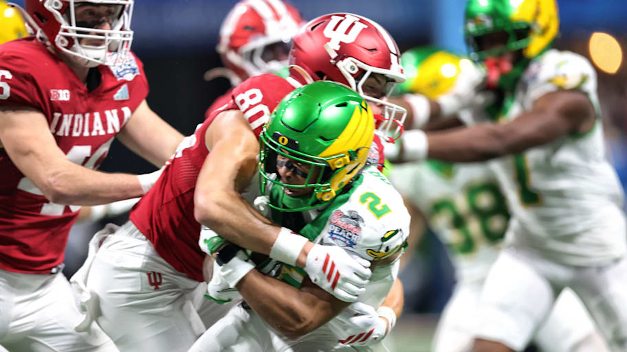 Oregon wide receiver Gary Bryant Jr. is tackled by Indiana’s Charlie Becker.