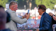 Pat McAfee takes a cell phone video of former Alabama coach Nick Saban on the “College GameDay” set.