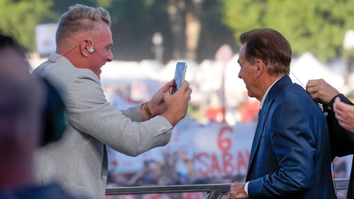Pat McAfee takes a cell phone video of former Alabama coach Nick Saban on the “College GameDay” set.