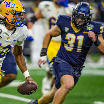 Pittsburgh Panthers quarterback Julian Dugger (12) escapes the pocket and runs during the second half of the 2024 GameAbove Sports Bowl at Ford Field in Detroit, on Thursday, Dec. 26, 2024.