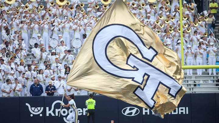 Sep 14, 2024; Atlanta, Georgia, USA; A Georgia Tech Yellow Jackets cheerleader runs a flag after a touchdown against the Virginia Military Institute Keydets in the second quarter at Bobby Dodd Stadium at Hyundai Field. Mandatory Credit: Brett Davis-Imagn Images