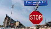 Vehicles hauling construction materials are seen along Fambrough Dr. and Illinois St. outside of David Booth Kansas Memorial Stadium Wednesday morning.
