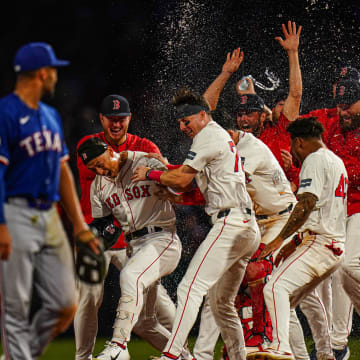 Aug 12, 2024; Boston, Massachusetts, USA; Boston Red Sox left fielder Rob Refsnyder (30) is congratulated after singling to center field to drive in the winning run against the Texas Rangers in the tenth inning at Fenway Park. Mandatory Credit: David Butler II-USA TODAY Sports