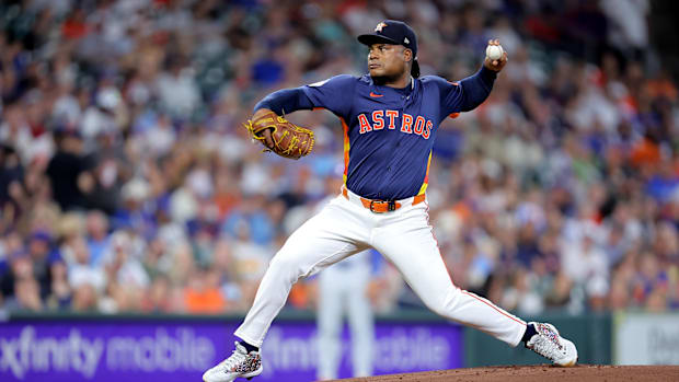 Framber Valdez of Houston Astros in navy blue jersey throws pitch from lefthand againsty Chicago Cubs