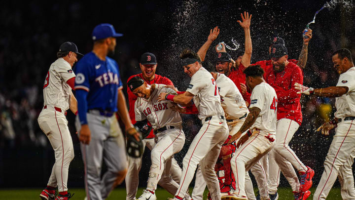 Aug 12, 2024; Boston, Massachusetts, USA; Boston Red Sox left fielder Rob Refsnyder (30) is congratulated after singling to center field to drive in the winning run against the Texas Rangers in the tenth inning at Fenway Park. Mandatory Credit: David Butler II-USA TODAY Sports