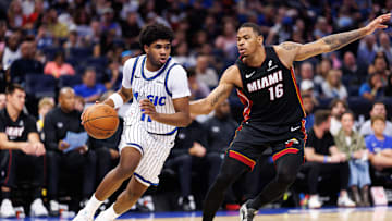 Oct 12, 2025; Orlando, Florida, USA; Orlando Magic guard Jase Richardson (11) drives to the basket while Miami Heat forward Keshad Johnson (16) defends during the second half at Kia Center. Mandatory Credit: Matt Pendleton-Imagn Images