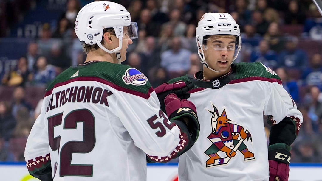 Apr 10, 2024; Vancouver, British Columbia, CAN; Arizona Coyotes defenseman Vladislav Kolyachonok (52) and forward Dylan Guenther (11) celebrate Kolyachonok’s goal against the Vancouver Canucks in the second period at Rogers Arena. Mandatory Credit: Bob Frid-Imagn Images