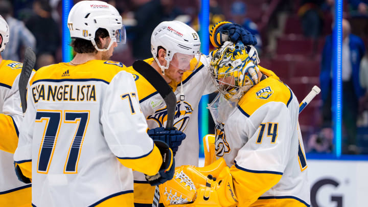 Apr 23, 2024; Vancouver, British Columbia, CAN;  Nashville Predators forward Luke Evangelista (77) and forward Gustav Nyquist (14) and goalie Juuse Saros (74) celebrate their victory against the Vancouver Canucks in game two of the first round of the 2024 Stanley Cup Playoffs at Rogers Arena. Mandatory Credit: Bob Frid-USA TODAY Sports