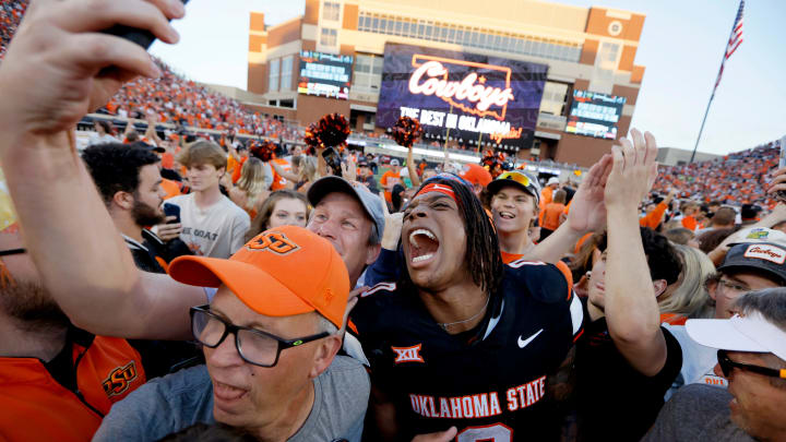 Oklahoma State Cowboys running back Ollie Gordon II (0) celebrates with fans after a Bedlam college football game between the Oklahoma State University Cowboys (OSU) and the University of Oklahoma Sooners (OU) at Boone Pickens Stadium in Stillwater, Okla., Saturday, Nov. 4, 2023. Oklahoma State won 27-24.