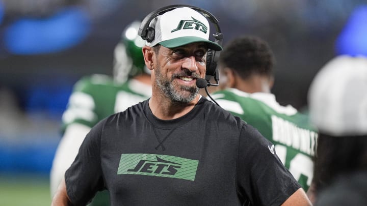 Aug 17, 2024; Charlotte, North Carolina, USA; New York Jets quarterback Aaron Rodgers (8) shares a laugh on the sidelines during the second half against the Carolina Panthers at Bank of America Stadium. Mandatory Credit: Jim Dedmon-USA TODAY Sports