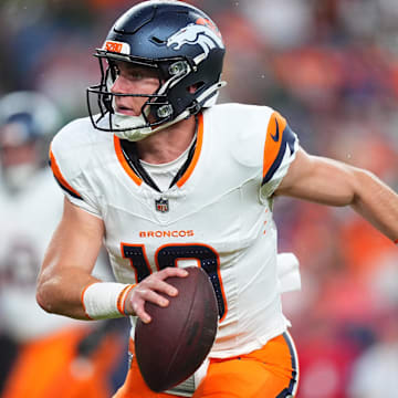 Aug 18, 2024; Denver, Colorado, USA; Denver Broncos quarterback Bo Nix (10) scrambles with the ball in the first quarter against the Green Bay Packers at Empower Field at Mile High. 