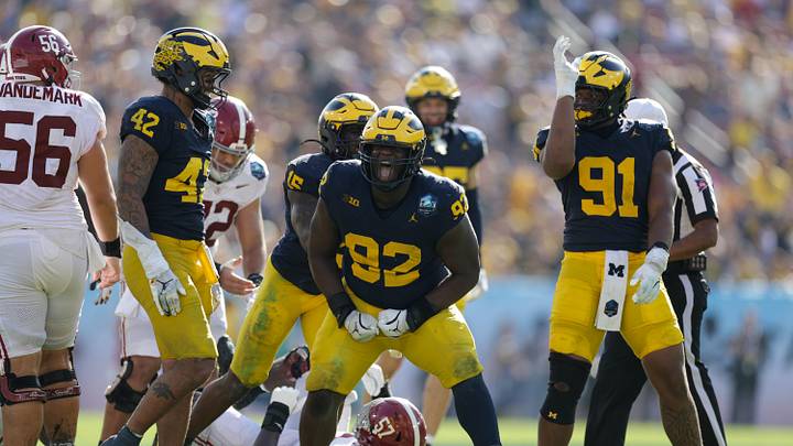 Dec 31, 2024; Tampa, FL, USA;  Alabama Crimson Tide quarterback Jalen Milroe (4) is sacked by Michigan Wolverines defensive lineman Ike Iwunnah (92) in the third quarter during the ReliaQuest Bowl at Raymond James Stadium. Mandatory Credit: Nathan Ray Seebeck-Imagn Images