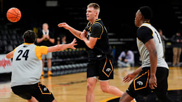 Iowa’s Bennett Stirtz (14) passes the ball as Tate Sage (24) and Cam Manyawu (3) defend during practice Oct. 15, 2025 at Carver-Hawkeye Arena in Iowa City, Iowa.