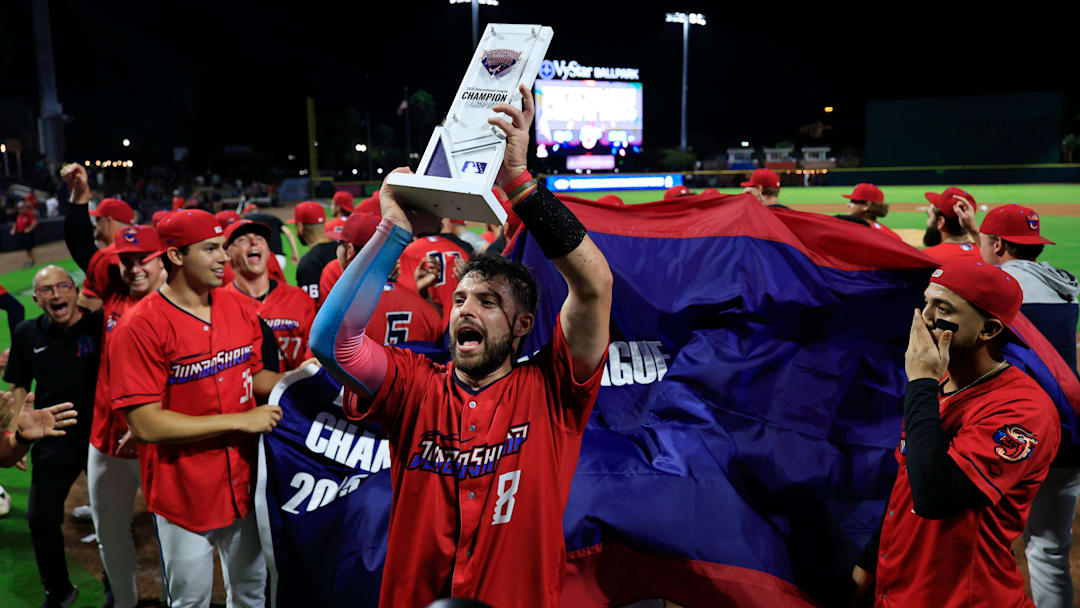 Jacksonville Jumbo Shrimp catcher Joe Mack (8) lifts the championship trophy after the game of Game 3 of an MiLB International League Championship Series at VyStar Ballpark Thursday, Sept. 25, 2025 in Jacksonville, Fla. The Jacksonville Jumbo Shrimp defeated the Scranton/Wilkes-Barre RailRiders 7-4 and took home the title in a best-of-three game series.