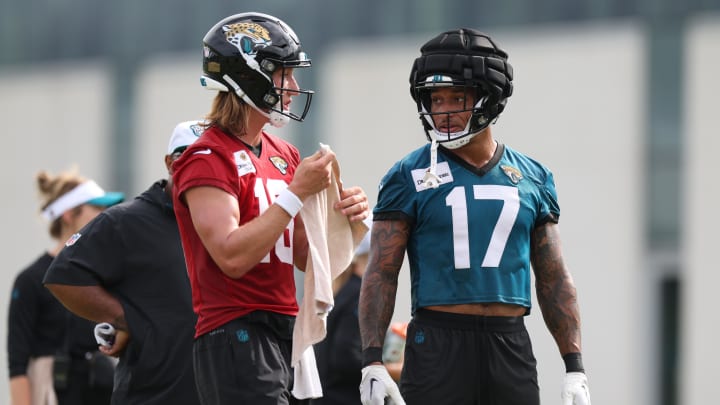 Jul 25, 2024; Jacksonville, FL, USA; Jacksonville Jaguars quarterback Trevor Lawrence (16) and tight end Evan Engram (17) participate in training camp at Miller Electric Center Mandatory Credit: Nathan Ray Seebeck-USA TODAY Sports