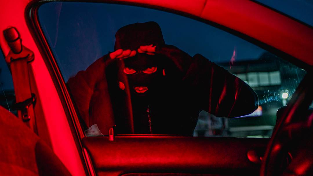 Car thief looking through car window Car thief looking through car window