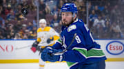 Jan 3, 2025; Vancouver, British Columbia, CAN; Vancouver Canucks forward J.T. Miller (9) reaches for the flying puck against the Nashville Predators in the second period at Rogers Arena. Mandatory Credit: Bob Frid-Imagn Images