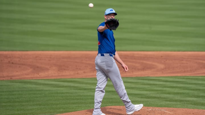 Feb 24, 2024; Scottsdale, Arizona, USA; Chicago Cubs pitcher Drew Smyly (11) reaches back to grab a ball in the late innings during spring training game at Scottsdale Stadium against the San Francisco Giants. Mandatory Credit: Allan Henry-USA TODAY Sports