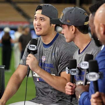 Oct 20, 2024; Los Angeles, California, USA; Fox Sports broadcasters David Ortiz and Alex Rodriguez talk with Los Angeles Dodgers designated hitter Shohei Ohtani (17) and his interpreter Will Ireton after the Los Angeles Dodgers defeated the New York Mets in game six of the NLCS to advance to the World Series in the 2024 MLB playoffs at Dodger Stadium. Mandatory Credit: Kiyoshi Mio-Imagn Images