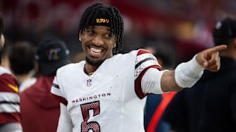 Sep 29, 2024; Glendale, Arizona, USA; Washington Commanders quarterback Jayden Daniels (5) celebrates against the Arizona Cardinals at State Farm Stadium. Mandatory Credit: Mark J. Rebilas-Imagn Images
