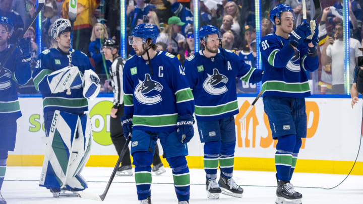 May 20, 2024; Vancouver, British Columbia, CAN; Vancouver Canucks defenseman Quinn Hughes (43) and forward J.T. Miller (9) and defenseman Nikita Zadorov (91) and goalie Arturs Silvos (31) wave to the crowd after the Edmonton Oilers win in game seven of the second round of the 2024 Stanley Cup Playoffs at Rogers Arena. Mandatory Credit: Bob Frid-USA TODAY Sports