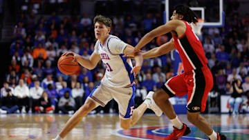 Jan 25, 2025; Gainesville, Florida, USA; Florida Gators forward Alex Condon (21) drives to the basket while Georgia Bulldogs guard Jordyn Kee (4) defends during the second half at Exactech Arena at the Stephen C. O'Connell Center. Mandatory Credit: Matt Pendleton-Imagn Images