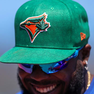 Toronto Blue Jays first baseman Vladimir Guerrero Jr. (27) wears a green MLB hat for St. Patrick’s day during a spring training game against the New York Yankees at TD Ballpark on March 17.