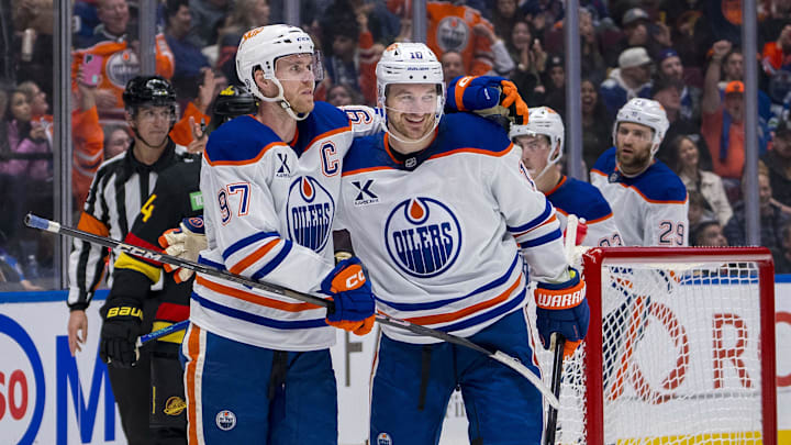 Nov 9, 2024; Vancouver, British Columbia, CAN; Edmonton Oilers forward Connor McDavid (97) celebrates with forward Zach Hyman (18) after scoring a goal against the Vancouver Canucks during the third period at Rogers Arena. Mandatory Credit: Bob Frid-Imagn Images